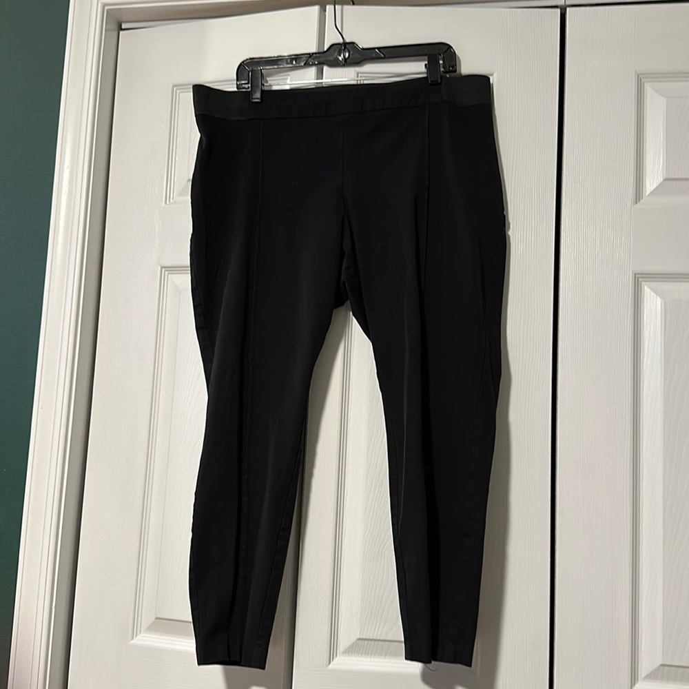 Stretch, black dress pants with a seam straight down the front of each leg.